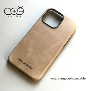 Brown leather phone case with 'Now or Never' engraving on a light background, featuring the COE Leather brand.