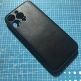 Black phone case on a blue cutting mat